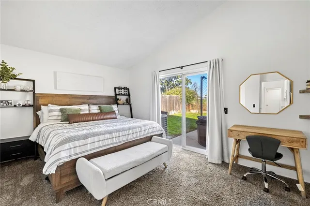 a bedroom with a bed a mirror and a window