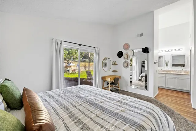 a bedroom with a bed a fireplace and a large window
