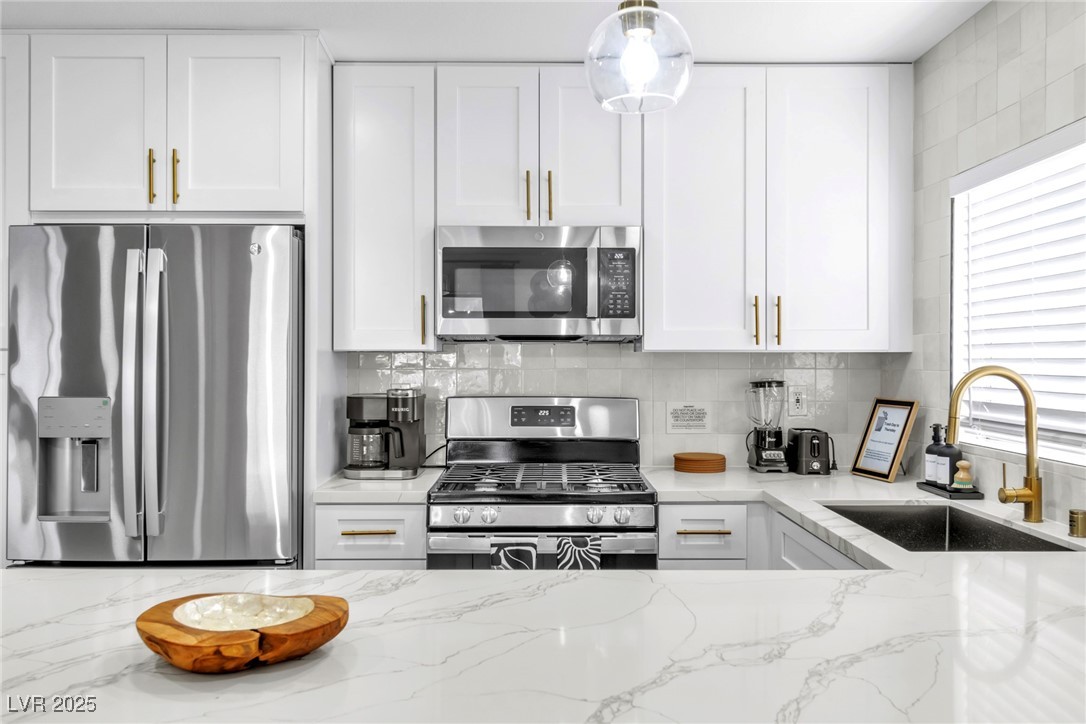 425 Golden Valley Drive Henderson, NV 89002 - Photo 11 of 48 Kitchen with stainless steel appliances, white cab