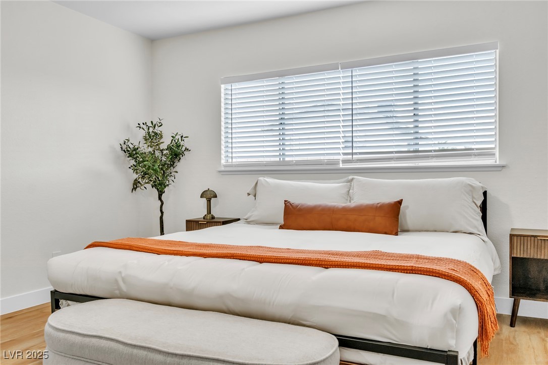 425 Golden Valley Drive Henderson, NV 89002 - Photo 27 of 48 Bedroom with light wood-style flooring and baseboa