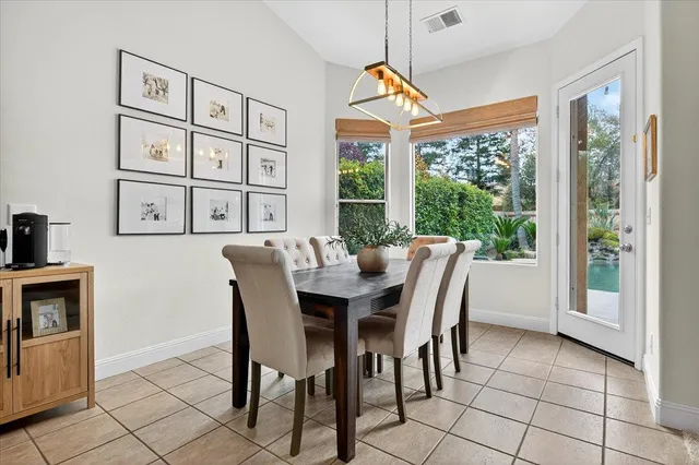 a view of a dining room with furniture large windows and wooden floor