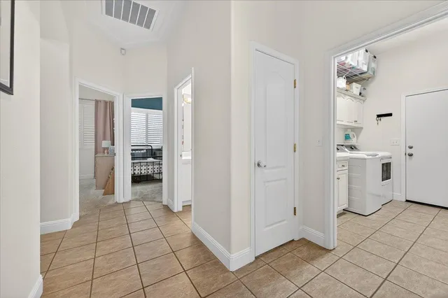 a view of kitchen with refrigerator and window