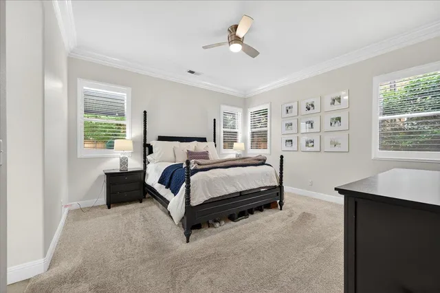 a bedroom with a bed lamp and a window