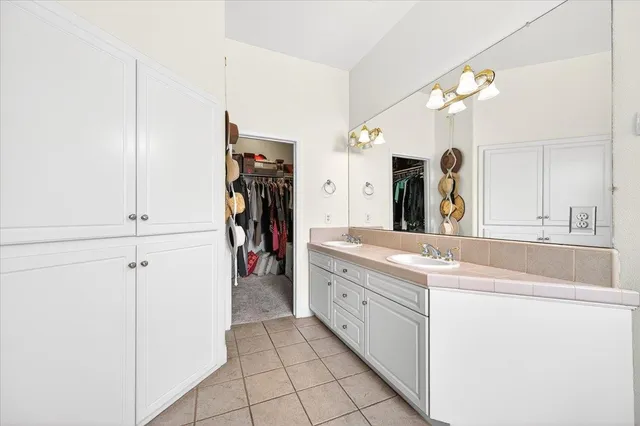 a large bathroom with a sink a mirror and a shower