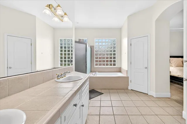 a bathroom with a sink a vanity and a mirror