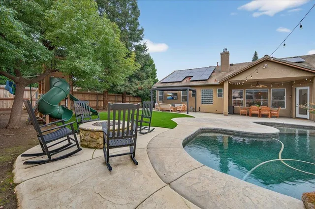 a view of a house with a lounge chairs in a patio