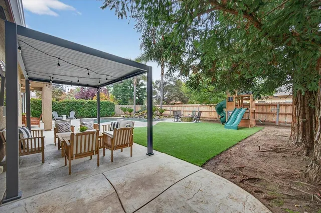 a patio with garden area and outdoor seating