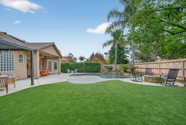 a view of a house with a yard porch and sitting area