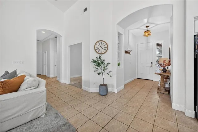 a living room with furniture and flowers