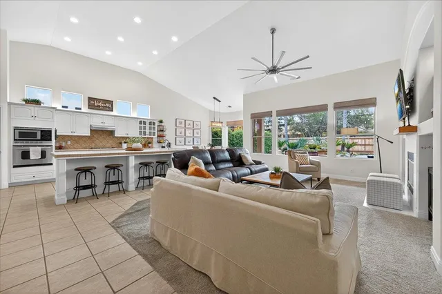 a living room with furniture and a kitchen view