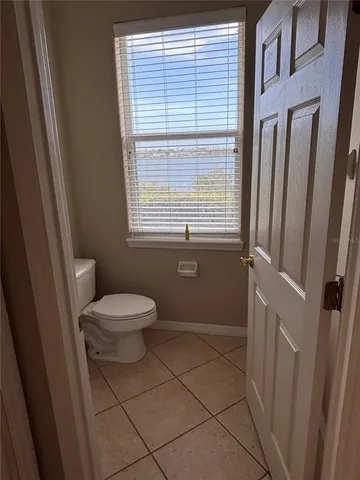 a bathroom with a toilet a sink a bath tub and a window