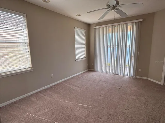 a view of a glass door with a balcony from a window