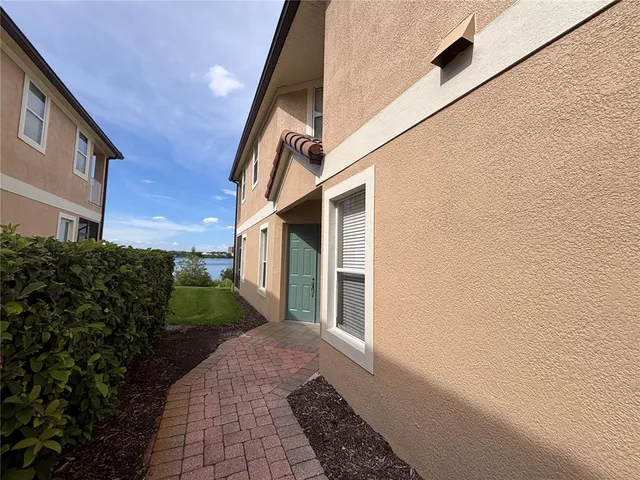a path view of a house with a yard