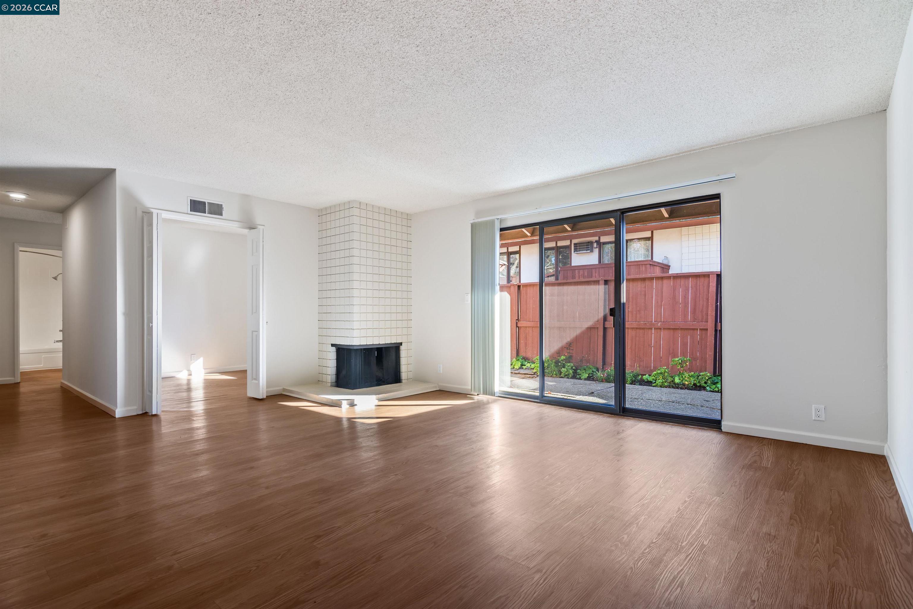 238-240 Camelback Road Pleasant Hill, CA 94523 - Photo 16 of 36 an empty room with wooden floor and windows