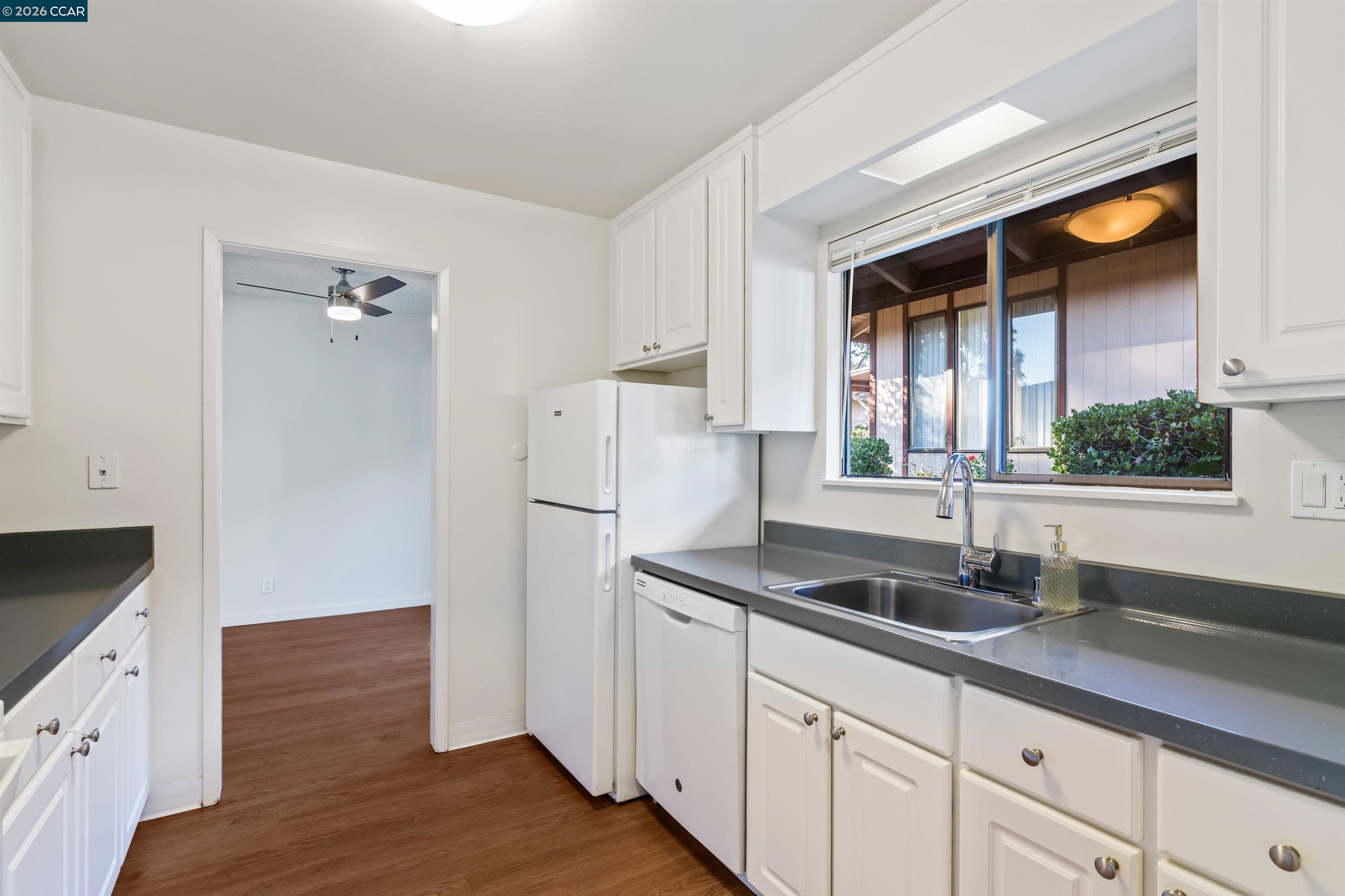 238-240 Camelback Road Pleasant Hill, CA 94523 - Photo 19 of 36 a kitchen with granite countertop a sink and a refrigerator