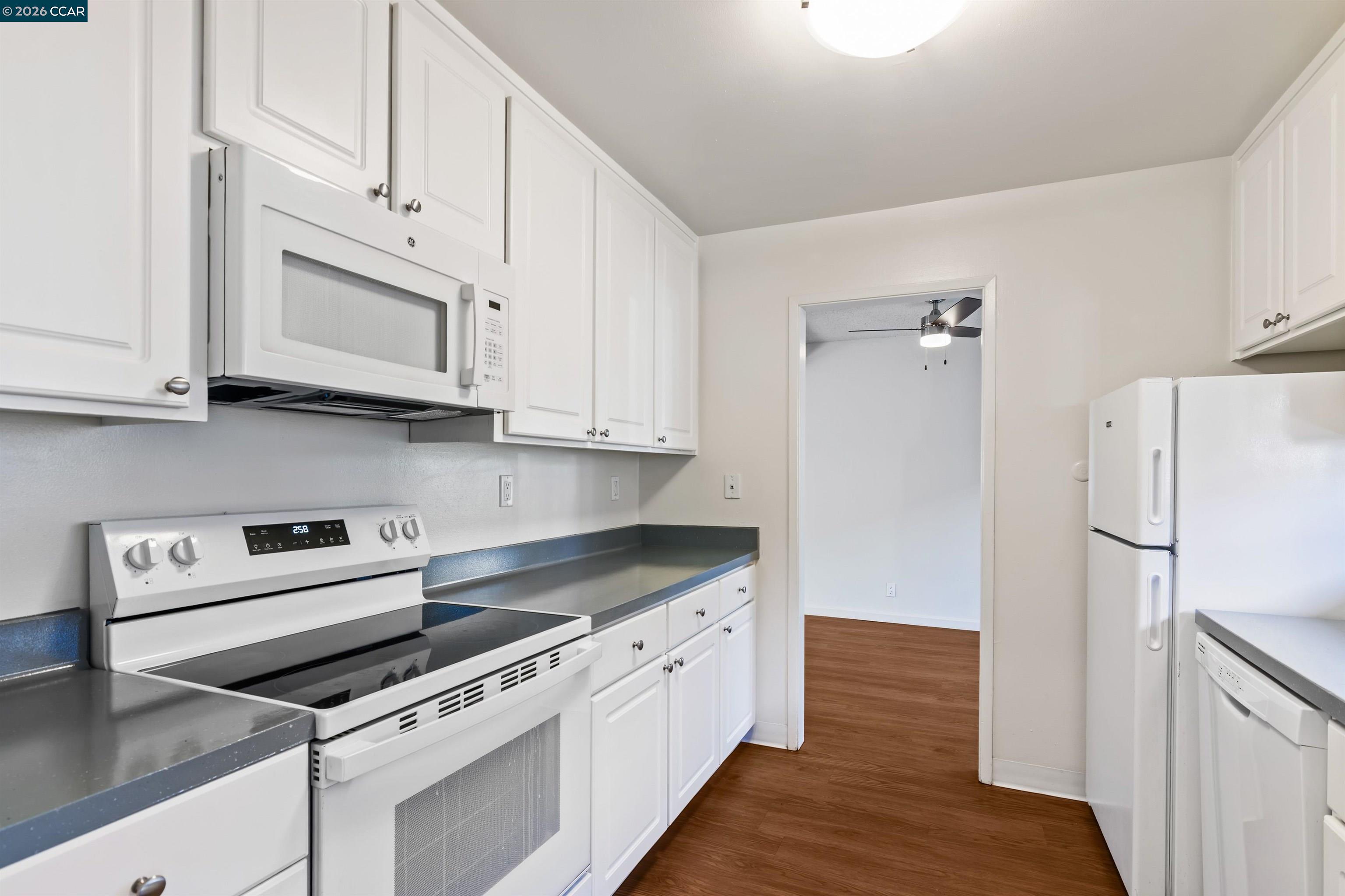 238-240 Camelback Road Pleasant Hill, CA 94523 - Photo 20 of 36 a kitchen with granite countertop white cabinets and white appliances