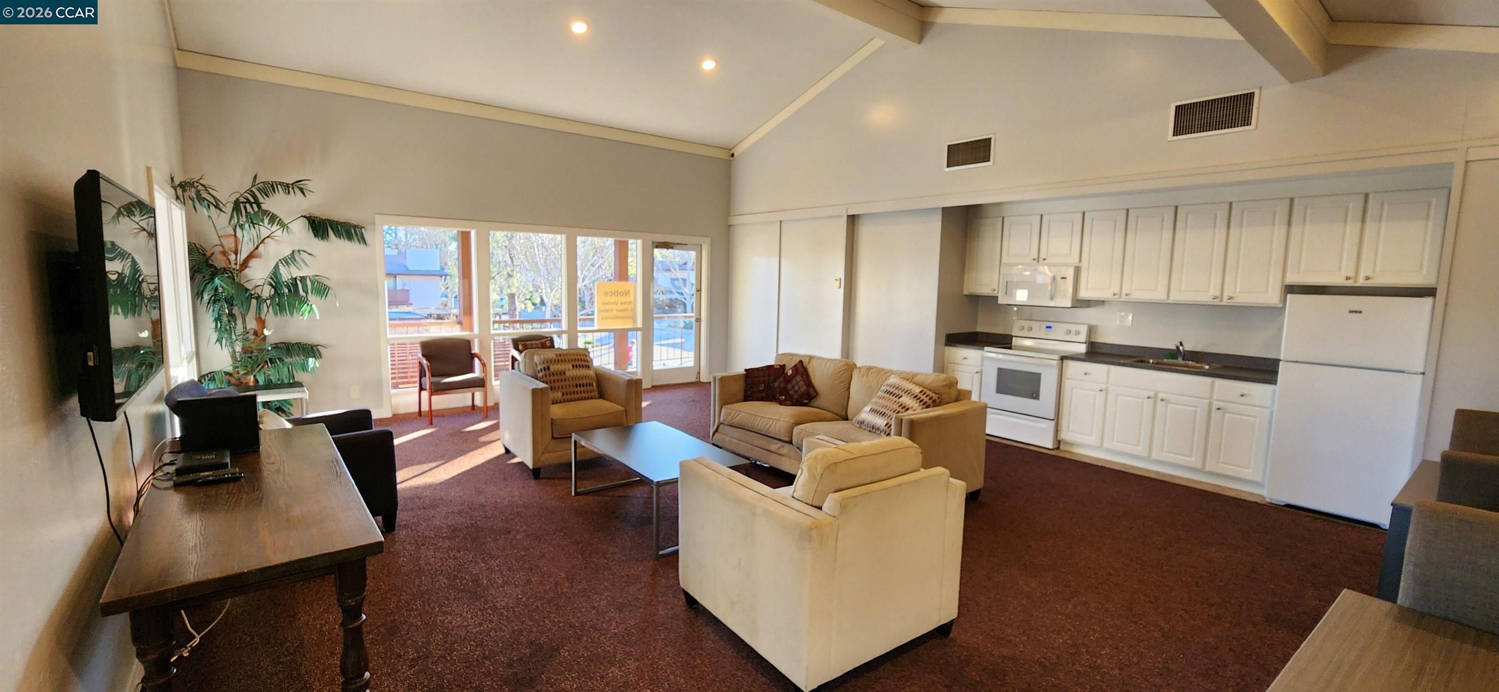 238-240 Camelback Road Pleasant Hill, CA 94523 - Photo 34 of 36 a living room with couches a flat tv screen and a dining table with wooden floor
