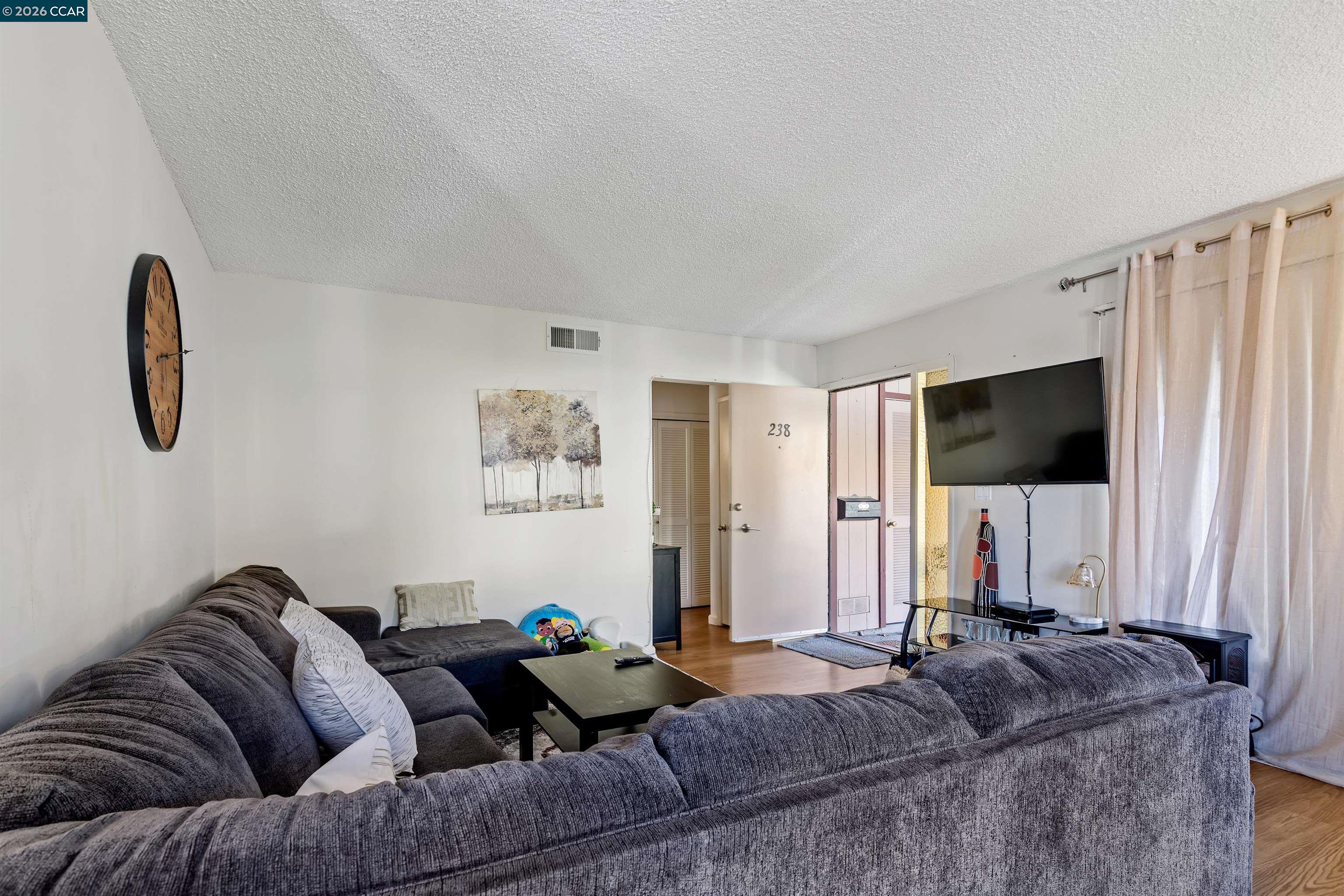 238-240 Camelback Road Pleasant Hill, CA 94523 - Photo 6 of 36 a living room with furniture and a flat screen tv