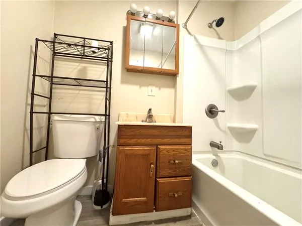 a bathroom with a toilet a sink and a bathtub