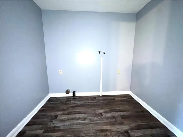 a view of a room with wooden floor