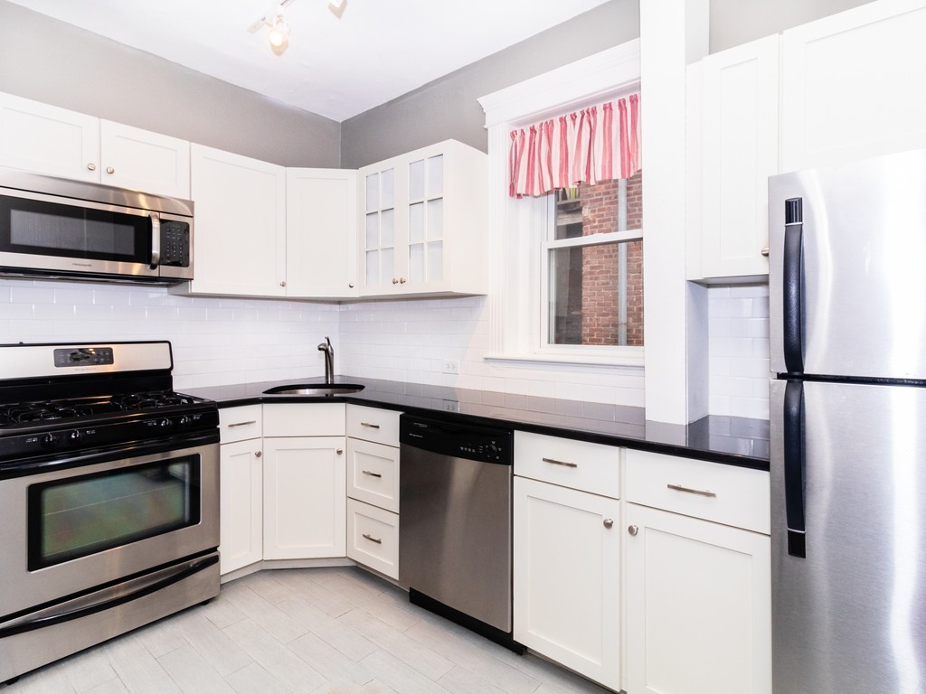 38 Kilsyth Road, Unit 22 Brookline, MA 02445 - Photo 2 of 18 a kitchen with cabinets stainless steel appliances and a sink