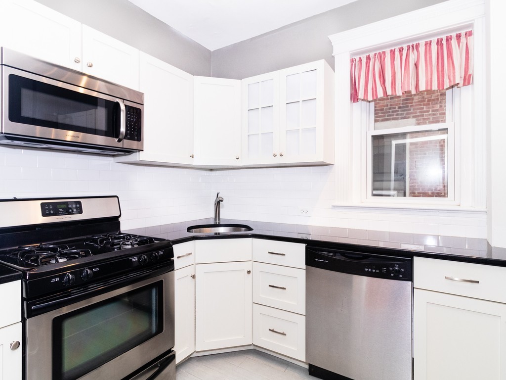 38 Kilsyth Road, Unit 22 Brookline, MA 02445 - Photo 3 of 18 a kitchen with white cabinets and appliances