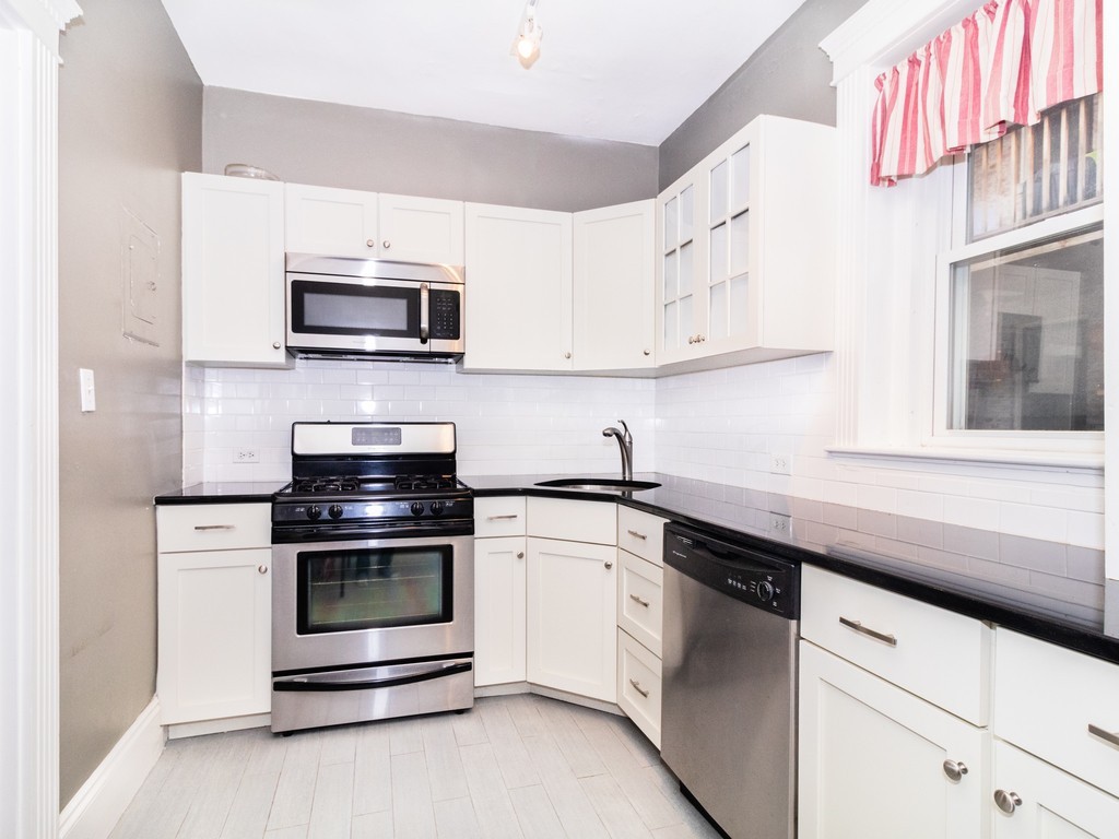 38 Kilsyth Road, Unit 22 Brookline, MA 02445 - Photo 4 of 18 a kitchen with cabinets stainless steel appliances and sink