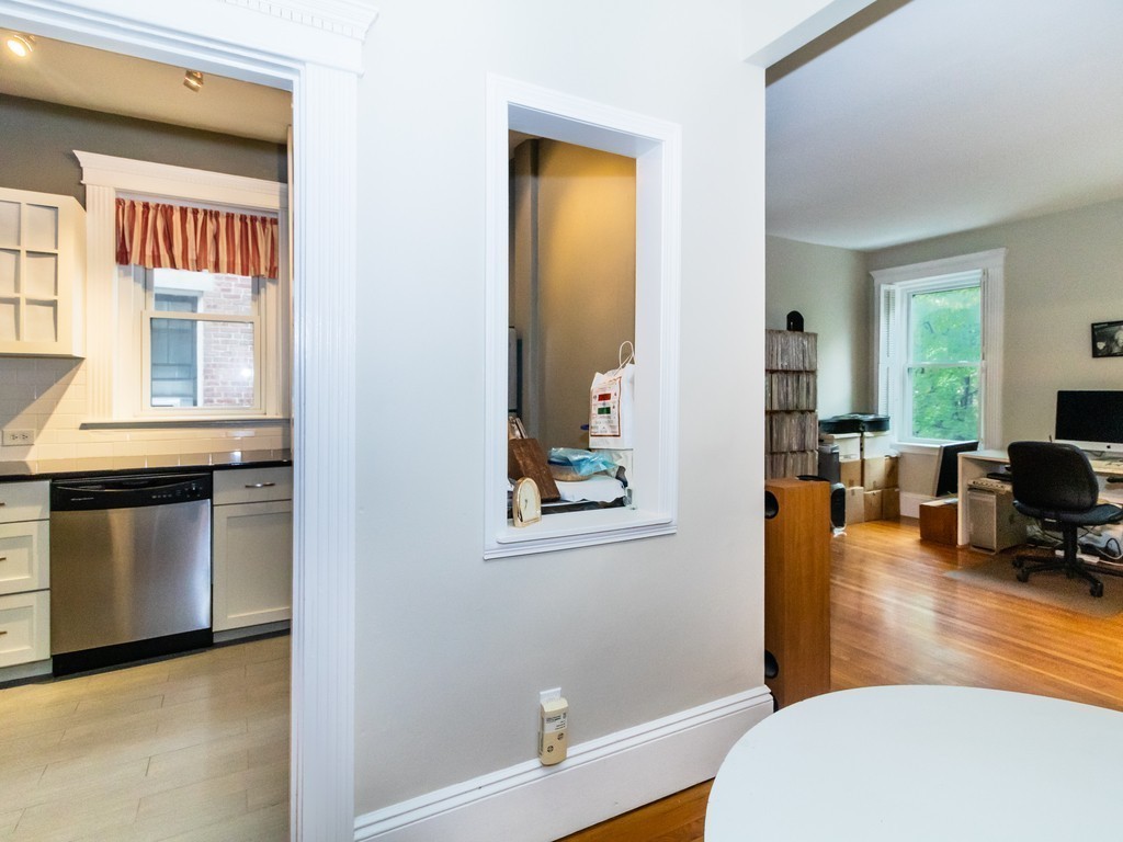 38 Kilsyth Road, Unit 22 Brookline, MA 02445 - Photo 5 of 18 a living room with stainless steel appliances furniture a fireplace and a window