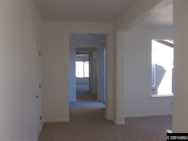 491 Alysheba Court Reno, NV 89521 - Photo 3 of 9 a view of hallway with a window and a livingroom