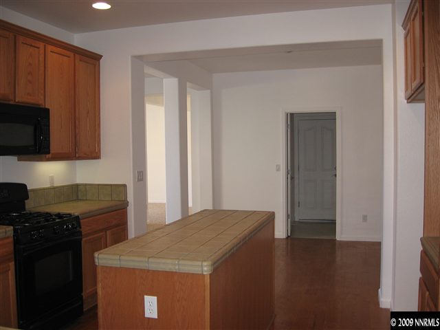 491 Alysheba Court Reno, NV 89521 - Photo 5 of 9 a kitchen with a stove and a microwave