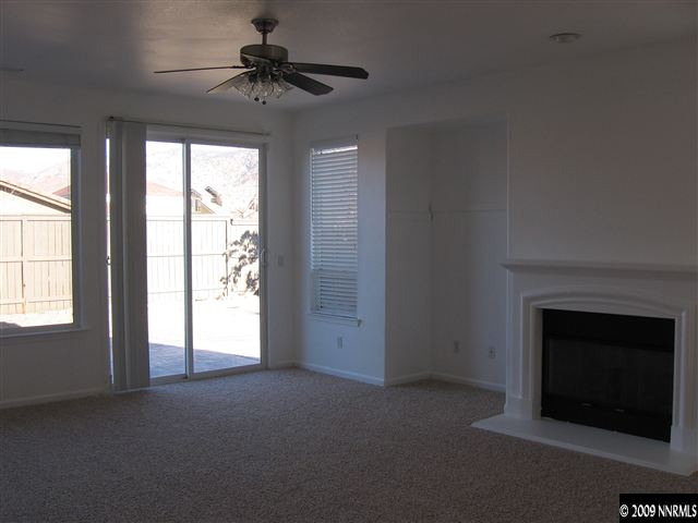 491 Alysheba Court Reno, NV 89521 - Photo 7 of 9 a view of empty room with a fireplace