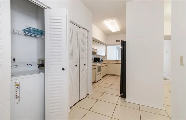 an empty room with a window and a ceiling fan