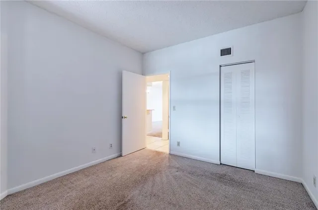 an empty room and chandelier fan