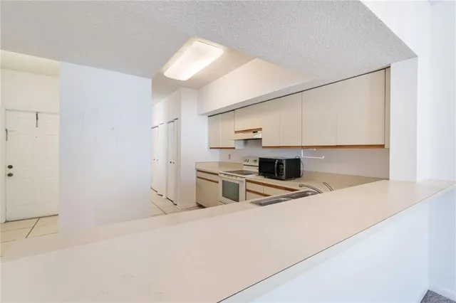 a kitchen with stainless steel appliances a stove a sink and a refrigerator