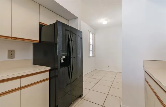 a kitchen with stainless steel appliances cabinets and a refrigerator