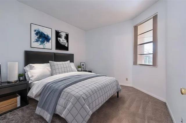 a bedroom with bed and a window