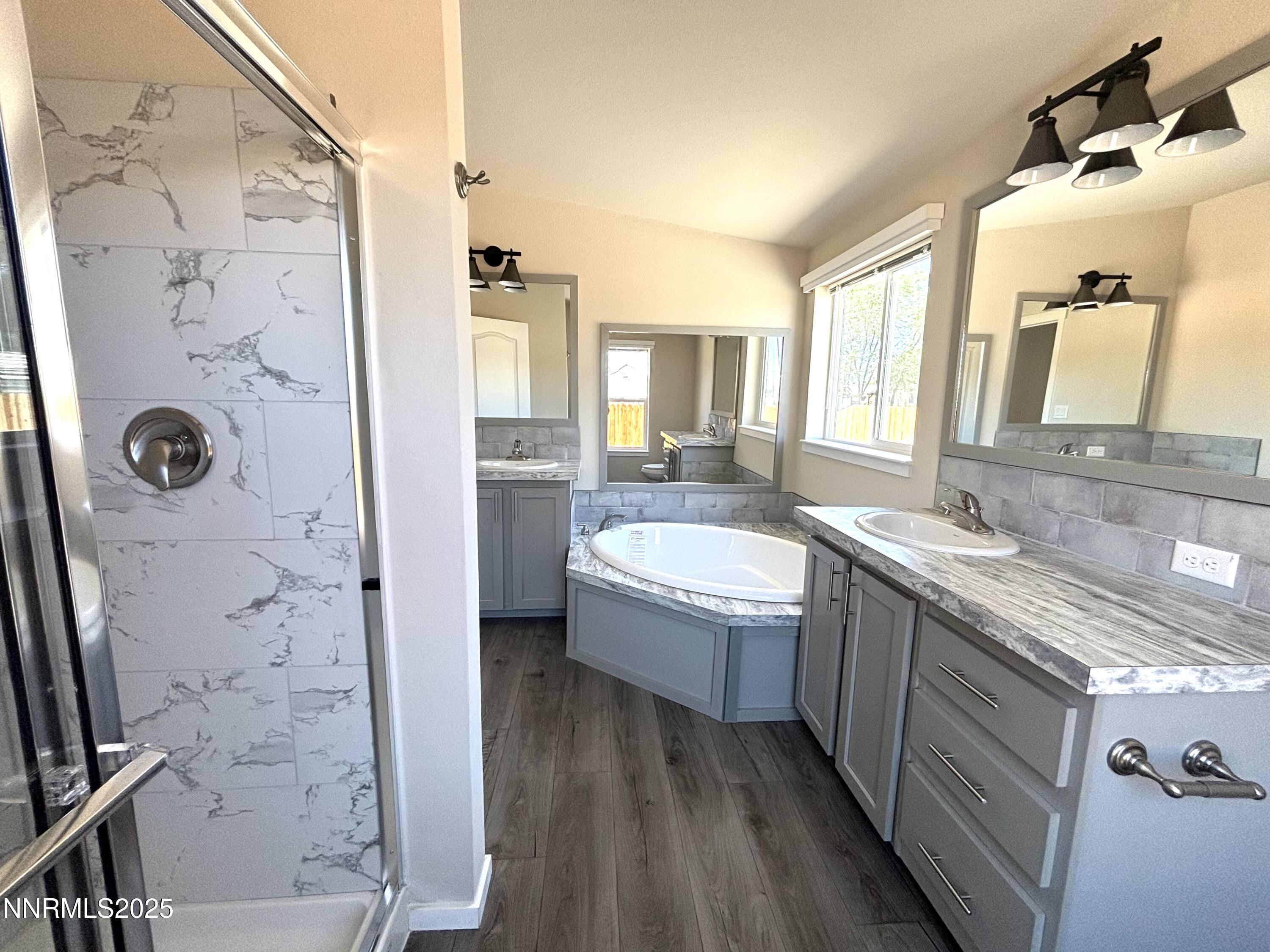 750 16th Street Lovelock, NV 89419 - Photo 13 of 17 a spacious bathroom with a granite countertop bathtub a sink and a shower