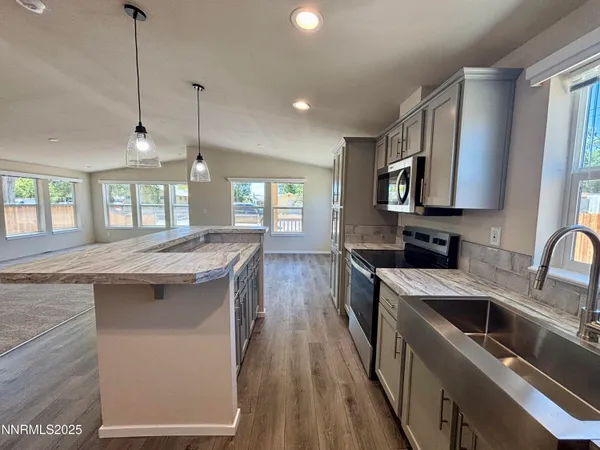 a kitchen with a stove sink and cabinets