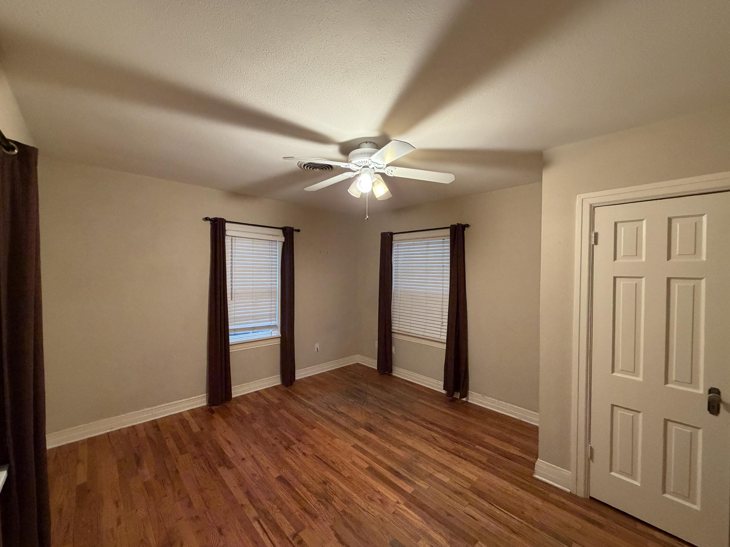 3110 22nd Street Lubbock, TX 79410 - Photo 18 of 22 a view of an empty room with wooden floor