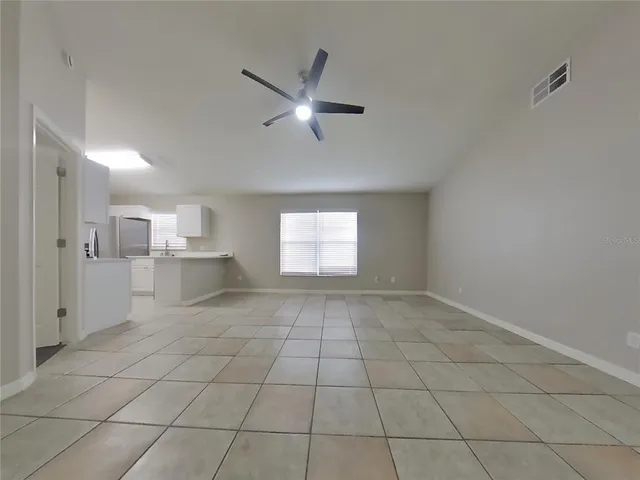 a view of a livingroom with a ceiling fan and window