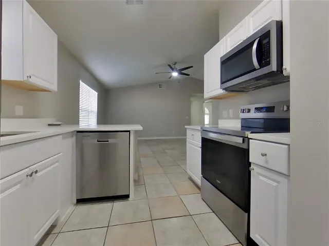 a kitchen with cabinets and appliances