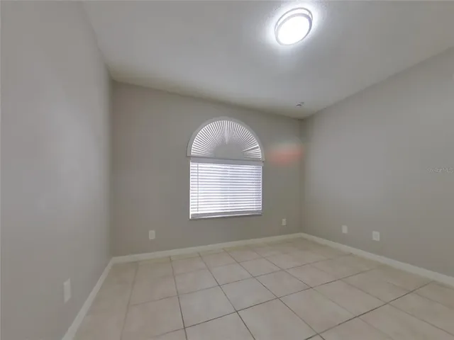 an empty room with a empty space and windows