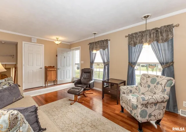 a kitchen with granite countertop a dining table chairs and a large window