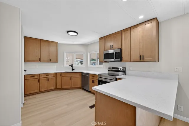 a kitchen with a sink cabinets and window