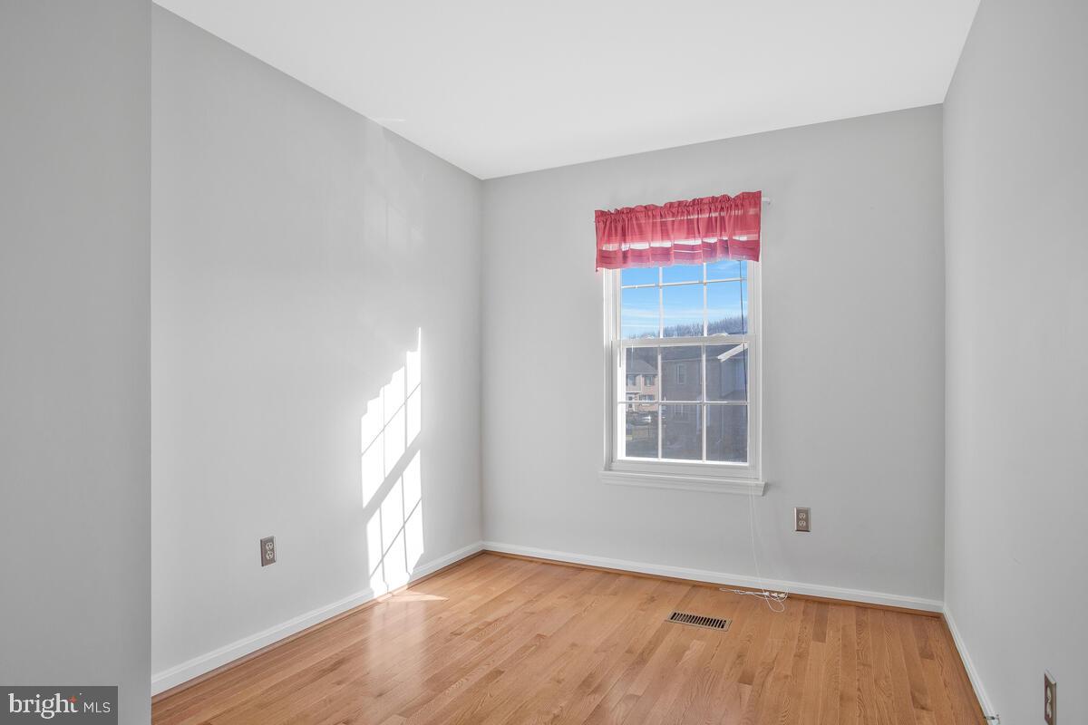 4 Offspring Court Perry Hall, MD 21128 - Photo 19 of 38 a view of an empty room with wooden floor and a window