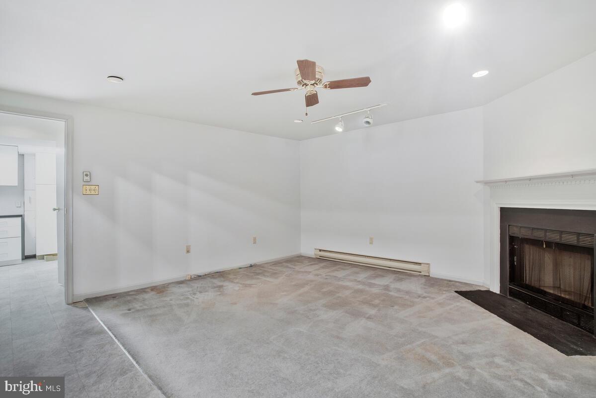 4 Offspring Court Perry Hall, MD 21128 - Photo 24 of 38 an empty room with fireplace and fan