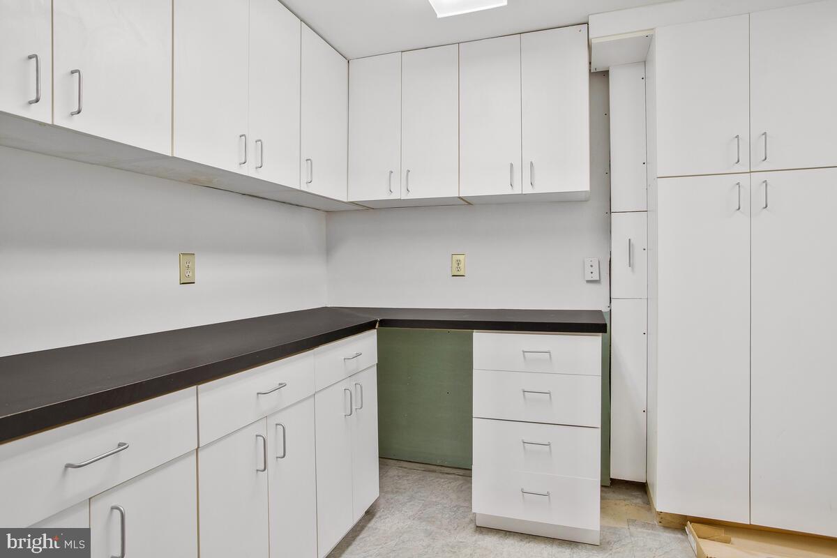 4 Offspring Court Perry Hall, MD 21128 - Photo 28 of 38 a kitchen with white cabinets and a refrigerator