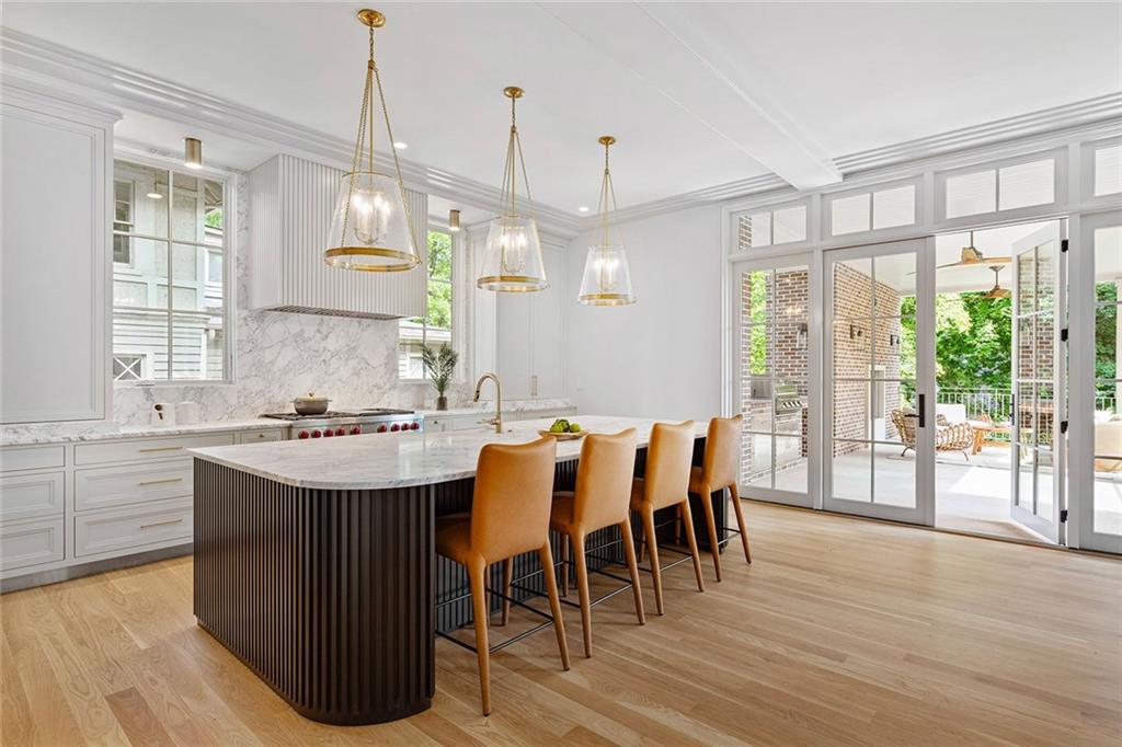 27 Maddox Drive Northeast Atlanta, GA 30309 - Photo 14 of 60 a view of a dining room and livingroom with furniture wooden floor a chandelier