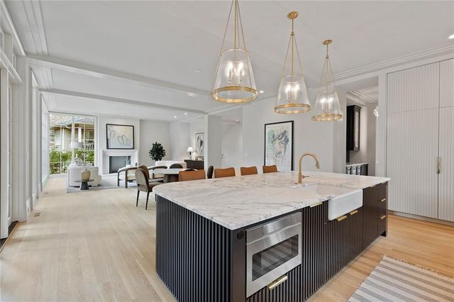 a living room with furniture fireplace and a large window