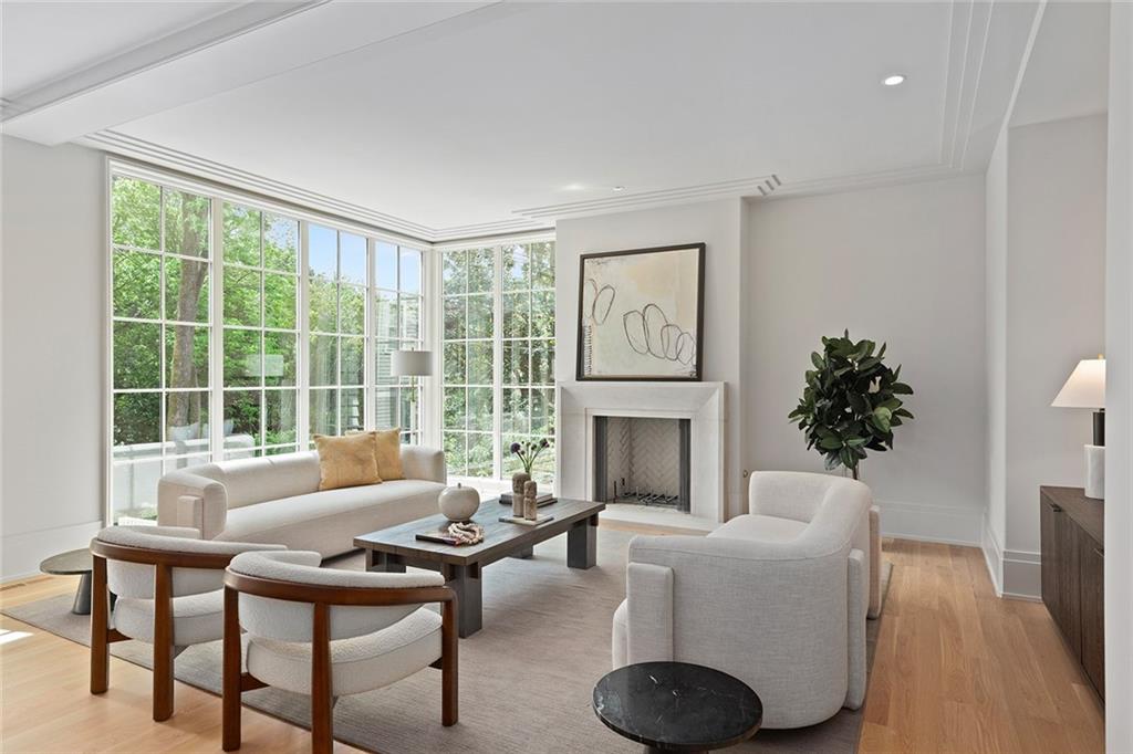 27 Maddox Drive Northeast Atlanta, GA 30309 - Photo 20 of 60 a living room with furniture a fireplace and a potted plant